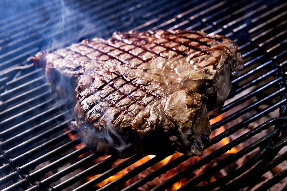 Porterhouse steak bake on the grill of the barbecue